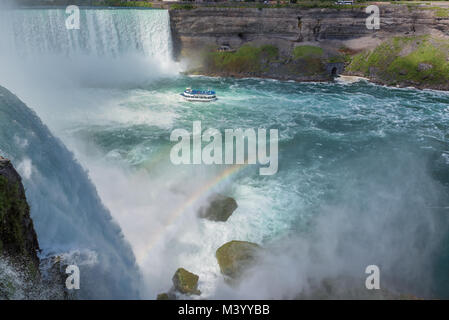 Niagara Falls, Tour Boat under Horseshoe Waterfall with Rainbow Stock Photo