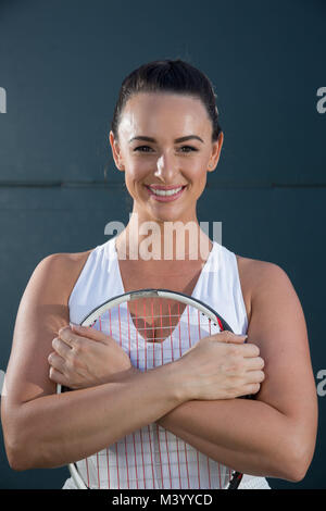 A young woman tennis player poses for a portrait  on a tennis court in Beverly Hills, California. Photo by Francis Specker Stock Photo