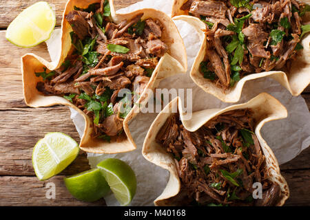 Mexican barbacoa tacos with spicy pulled beef close-up on the table. horizontal top view from above Stock Photo