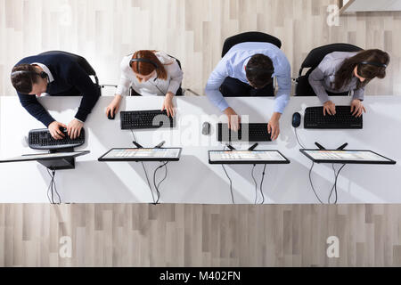 Elevated View Of Call Center Operator Team With Headset Working In Office Stock Photo