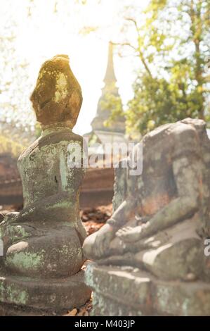 Ancient outdoor Buddhas field of broken sculpture in Wat Umong Suan Puthatham.The temple is a 700 year was built in 1297 in Chiang Mai city, Thailand. Stock Photo