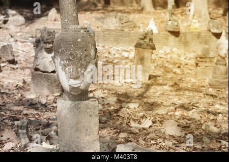 Ancient outdoor Buddhas field of broken sculpture in Wat Umong Suan Puthatham.The temple is a 700 year was built in 1297 in Chiang Mai city, Thailand. Stock Photo