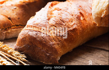 Fresh baked bread on wooden background Stock Photo