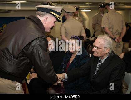 NORFOLK, Va. (Feb. 5, 2018) -- Capt. Richard McCormack, USS Gerald R. Ford's (CVN 78) commanding officer, greets the family of Chief Master-at-Arms Petermartin Noska, assigned to Ford's security department, during his commissioning ceremony held in the ship's forecastle. (U.S. Navy photo by Mass Communication Specialist 3rd Class Ryan Carter) Stock Photo