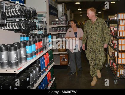 180206-N-JY474-030 CAMP LEMONNIER, Djibouti – Aurora Ramos, Branch Exchange Manager for base Navy Exchange, gives Adm. James G. Foggo, Commander U.S. Naval Forces Europe - Africa, a tour of the Camp Lemonnier NEX, Feb. 6. The purpose of Foggo’s visit was to visit the Sailors currently forward deployed to Camp Lemonnier. (U.S. Navy photo by Mass Communication Specialist 2nd Class Jared E. Walker/Released). Stock Photo