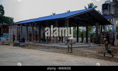 Soldiers and sailors from the Royal Thai Navy, Singapore Army and U.S. Navy, work together to build a multi-purpose class room for the Wat Sombum Naram school, Feb. 7, 2018, during exercise Cobra Gold 2018. Humanitarian civic action programs conducted during Cobra Gold 18 demonstrates a mutual commitment to support security and humanitarian interests of friends and partner nations. The programs will improve the quality of life as well as the general health and welfare of civilian residents in the exercise area. Exercise Cobra Gold 2018 is an annual exercise conducted in the Kingdom of Thailand Stock Photo