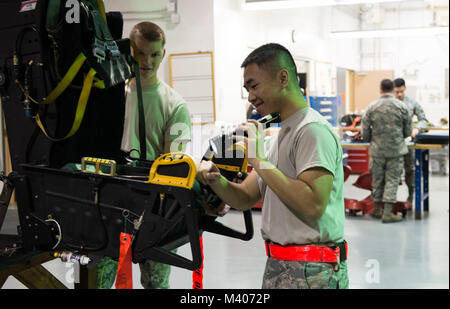 Airmen from the 18th Component Maintenance Squadron egress shop perform a visual inspection of an ejection seat Feb. 7, 2018, at Kadena Air Base, Japan. Egress is a specialized career field and requires attention to detail at all times. (U.S. Air Force photo by Senior Airman Jessica H. Smith) Stock Photo