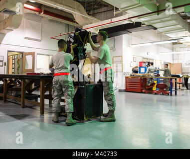 Airmen from the 18th Component Maintenance Squadron egress shop prepare to perform a visual inspection of an ejection seat Feb. 7, 2018, at Kadena Air Base, Japan. Egress is a specialized career field and requires attention to detail at all times. (U.S. Air Force photo by Senior Airman Jessica H. Smith) Stock Photo