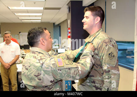 Maj. Mark Crimaldi (right) received the Army Commendation Medal from Recovery Field Office(RFO)-Puerto Rico commander Lt. Col. Roberto Solorzano (left) on February 8, 2018 for his work during the Hurricane Maria/Hurricane Irma response and recovery. Lt. Col. Solorzano and several staff members highlighted Maj. Crimaldi's leadership and contributions while deployed to the RFO as its deputy commander. The RFO manages temporary power, temporary roofing, debris and critical public facilities projects in support of the Commonwealth of Puerto Rico and the Federal Emergency Management Agency. Stock Photo