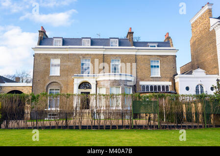 Clapham London, UK - January 2018: Facade of an opulent restored Victorian house luxury mansion in yellow bricks and white finishing with private gard