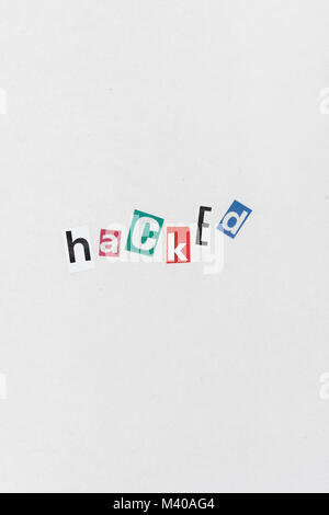 Hacked / Ransomware cutout letters message on sheet of plain newsprint. Ransomware message, ransom-ware attack, Russian hackers, China hackers. Stock Photo