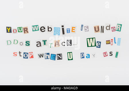 Hacked / Ransomware cutout letters message on sheet of plain newsprint. Ransomware message, ransom-ware attack, Russian hackers, China hackers. Stock Photo
