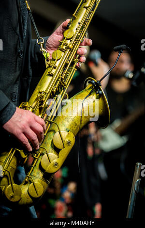 Saxophone player performing on the stage at night Stock Photo