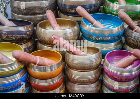 Colorful singing bowls with wooden mallets on a traditional market, Thamel, Kathmandu, Nepal Stock Photo