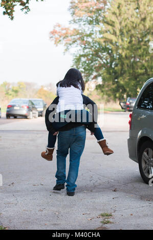 Brother Giving His Sister a Piggyback Ride