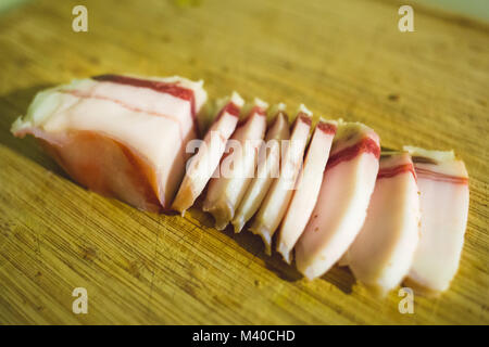 Salted Lard Bacon slices on wooden cutting board Stock Photo