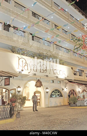 A security guard stands in front of the street entrance to the Playa Los Arcos hotel in the Zona Romantica neighborhood of Puerto Vallarta, Mexico. Stock Photo