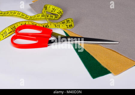 Set of tailoring tools, scissors and measuring tape, accessories and fabric Stock Photo