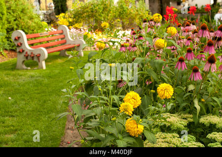 Nelson, British Columbia, Canada.  Flower garden and bench in Rotary Lakeside Park. Stock Photo