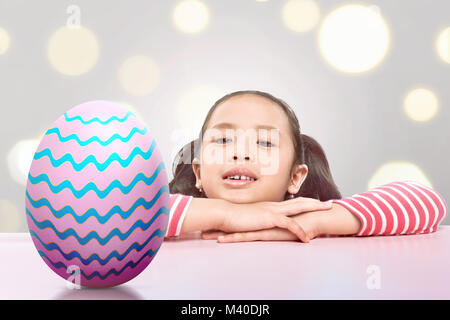 Joyful asian little child find easter eggs on the table Stock Photo