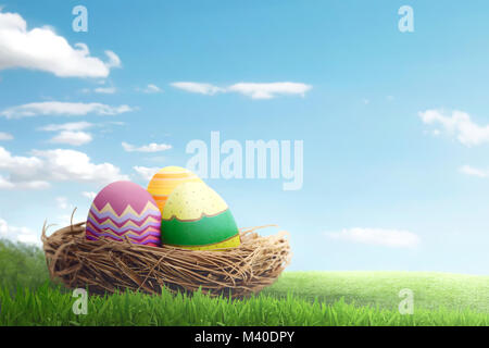 Colorful easter eggs on basket with blue sky background Stock Photo