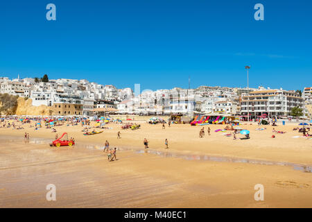 People relaxing and sunbathing on sandy beach. Albufeira, Portugal Stock Photo