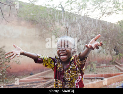 Sweet little African boy under the rain in Mali (Africa) Stock Photo