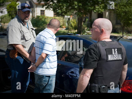 San Antonio, Aug. 9, 2011 - United States Marshals, Lone Star Fugitive Task Force, arrest suspected child molester Benjamin W. Crumley outside his home in San Antonio Tuesday. The middle school teacher and soccer coach is accused of molesting three of his former female students.  Photo by: Shane T. McCoy / US Marshals US Marshals arrest child molester by U.S. Marshals Service Stock Photo