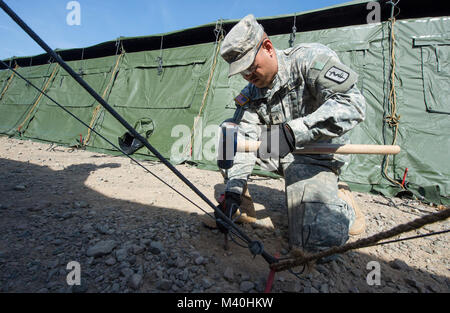 Members of the 212th Combat Support Hospital (CSH) build a fully functional field hospital at Miesau Army Depot, Germany on April 14, 2015. The 212th CSH field hospital was built in order to better prepare the unit for real world scenarios where rapid deployable hospitals are required. (DoD News photo by SSgt Brian Kimball) (DoD News photo by SSgt Brian Kimball) 150414-F-QP401-057 by DoD News Photos Stock Photo