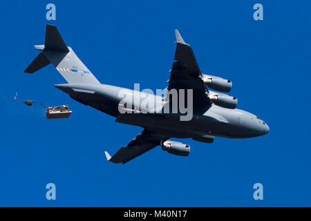 A NATO C-17 Globemaster III airdrops an M119 105mm Towed Howitzer assigned to the 173rd Infantry Brigade Combat Team in support of exercise Saber Strike 15 at the Drawsko Pomorskie Training Area in Poland, June 15, 2015. Saber Strike is a U.S. European Command-sponsored, Joint Chiefs of Staff-directed regional and multilateral command post and field exercise designed to increase interoperability between the United States and partner nations.  (U.S. Army photo by Spc. Marcus Floyd/Released) 150615-A-JI163-080 by AirmanMagazine Stock Photo