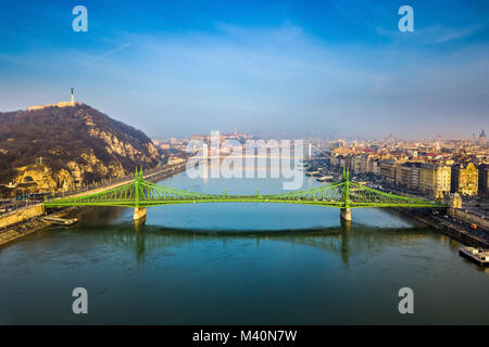 Budapest, Hungary - Aerial skyline view of beautiful Liberty Bridge (Szabadsag Hid) on a sunny morning with Gellert Hill, Citadella, Statue of Liberty Stock Photo