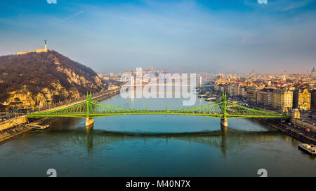 Budapest, Hungary - Aerial skyline view of beautiful Liberty Bridge (Szabadsag Hid) on a sunny morning with Gellert Hill, Citadella, Statue of Liberty Stock Photo