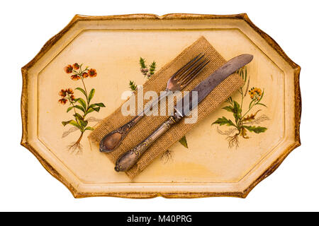 Antique tray with old cutlery spoon and knife isolated on white background, view from above, flatlay. Stock Photo