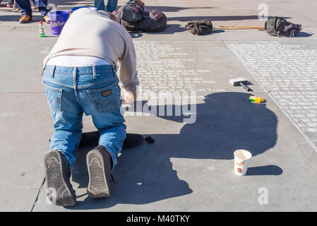 A street artist writing out poetry on the pavement in Trafalgar Square, London, UK. Stock Photo