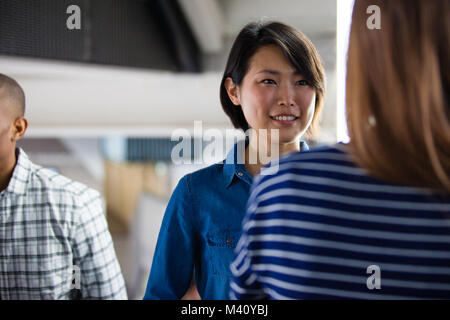 Female colleagues talking Stock Photo