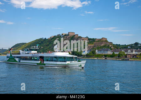 Excursion ship on Rhine river passing Ehrenbreitstein fortress at Coblenz, Rhineland-Palatinate, Germany, Europe Stock Photo