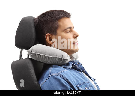 Young man with a neck pillow sleeping on a seat isolated on white background Stock Photo