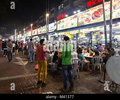 Kuala Lumpur, Malaysia - December 22 2017: Tourists and locals eating in Jalan Alor famous for its chinese food restaurant and street food stalls near Stock Photo