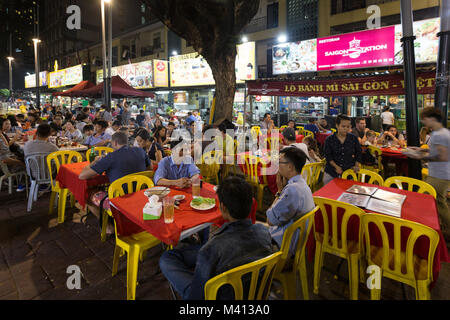 Kuala Lumpur, Malaysia - December 22 2017: Tourists and locals eating in Jalan Alor famous for its chinese food restaurant and street food stalls near Stock Photo