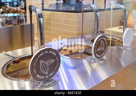 Chocolate dripping from fountain at Fino de Amora gelateria in Citylife, Milan, Italy Stock Photo
