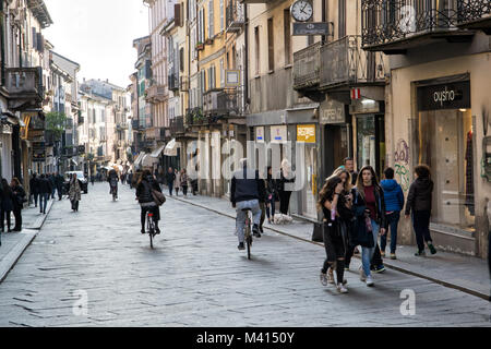 People walking on a street in Pavia, Lombardy, northern Italy Stock Photo