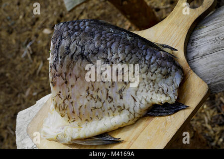 Crucian fillet on a cutting board in the field Stock Photo