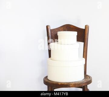 Three white boxes on a chair with copy space Stock Photo