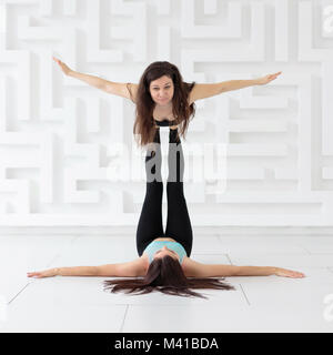 Young sporty women doing acroyoga Stock Photo