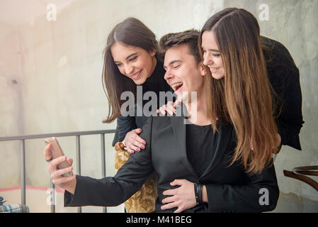 Three friends having fun in a cafe Stock Photo
