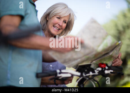 Senior couple looking at map on cycling vacation Stock Photo