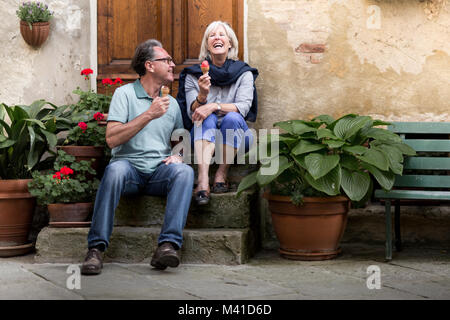 Senior couple eating gelato on vacation Stock Photo