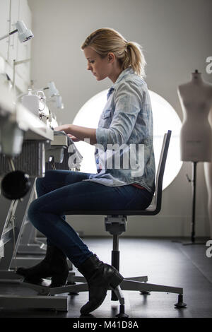Fashion student working on a sewing machine Stock Photo