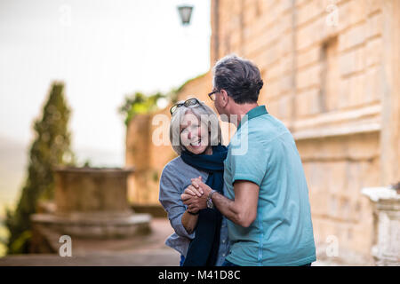 Senior couple dancing in the street on vacation Stock Photo