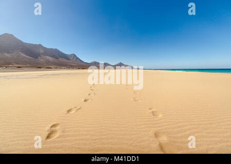 Fuerteventura - Amazing Cofete beach with endless horizon and traces on the sand. Volcanic hills in the background and Atlantic Ocean. Canary Islands. Stock Photo